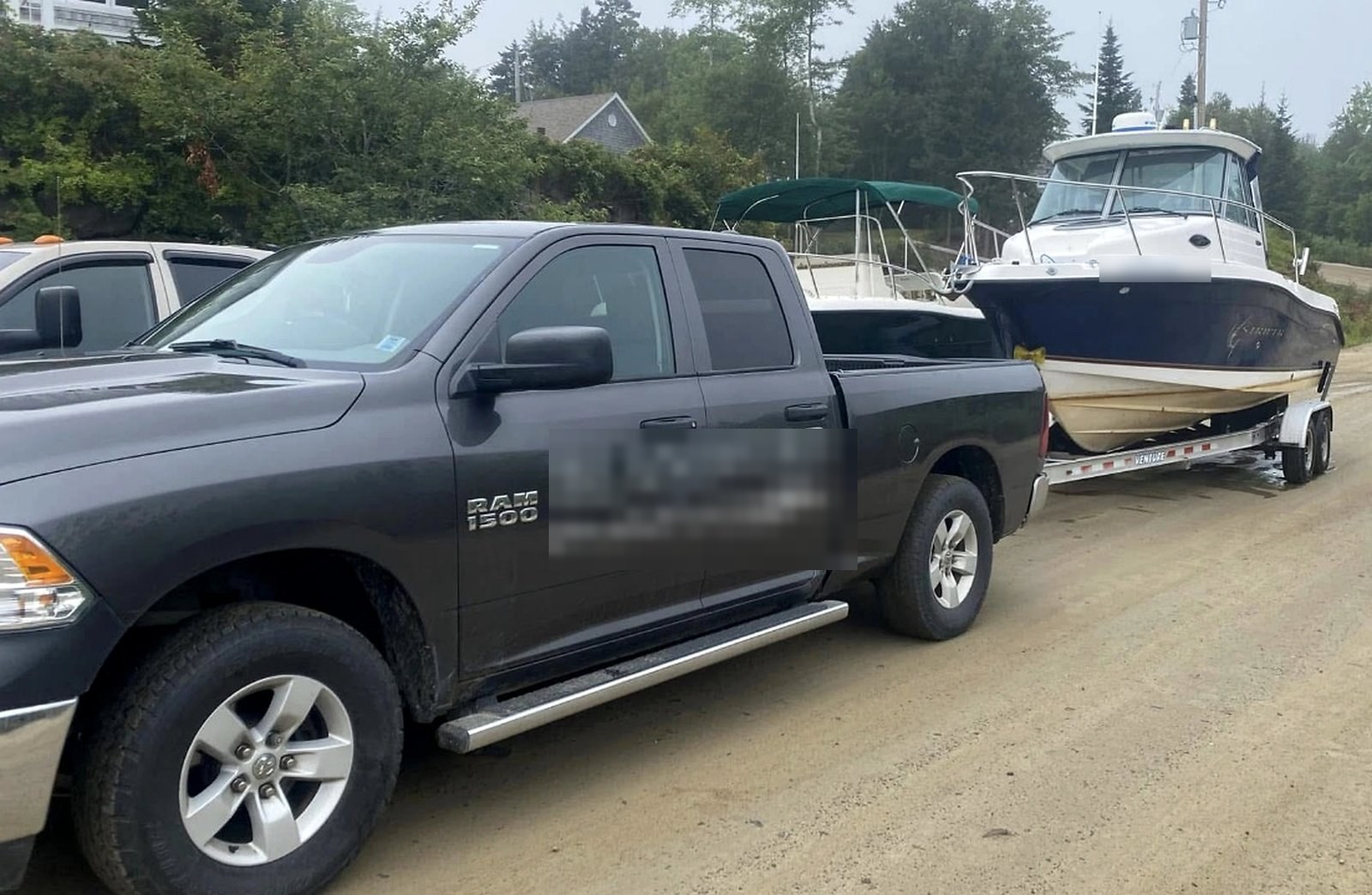 Coastal Marine Co. truck towing a boat